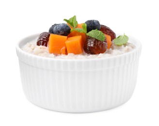 Photo of Delicious barley porridge with blueberries, pumpkin, dates and mint in bowl isolated on white