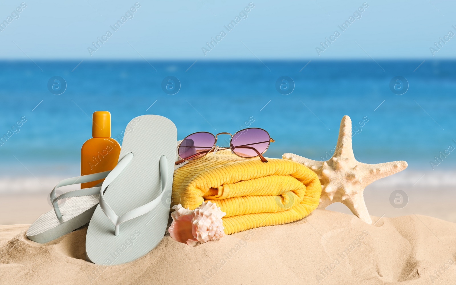 Image of Different beach objects on sandy beach near sea