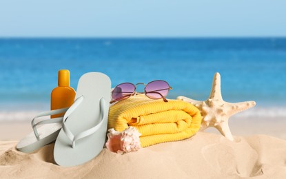 Image of Different beach objects on sandy beach near sea