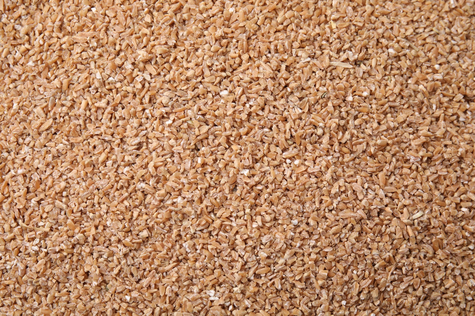 Photo of Dry wheat groats as background, top view