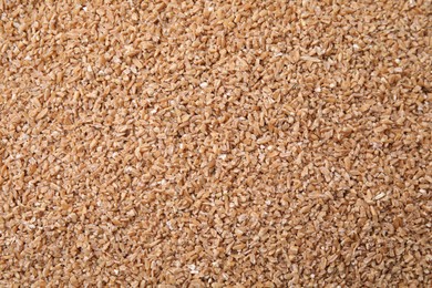 Dry wheat groats as background, top view