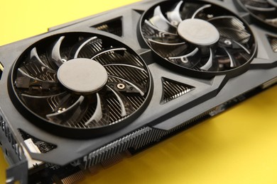 Photo of One graphics card on yellow background, closeup