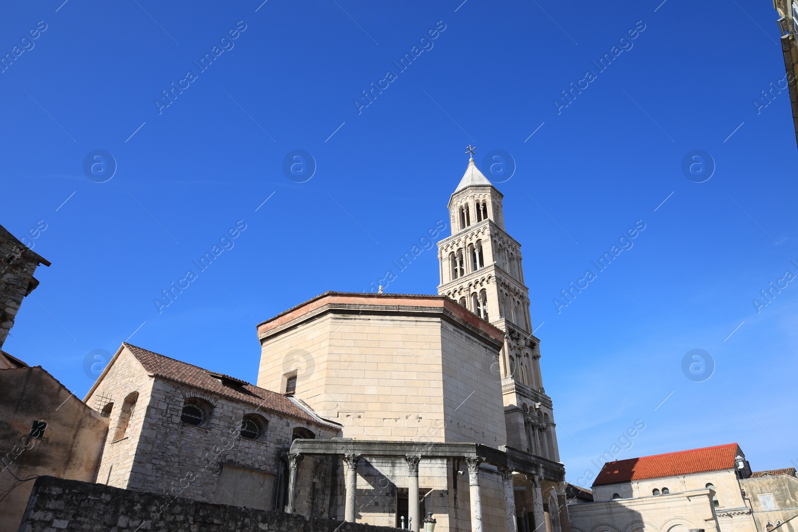 Photo of Beautiful old building against light blue sky, low angle view