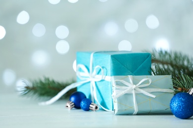 Photo of Christmas decorations on table against blurred background. Bokeh effect