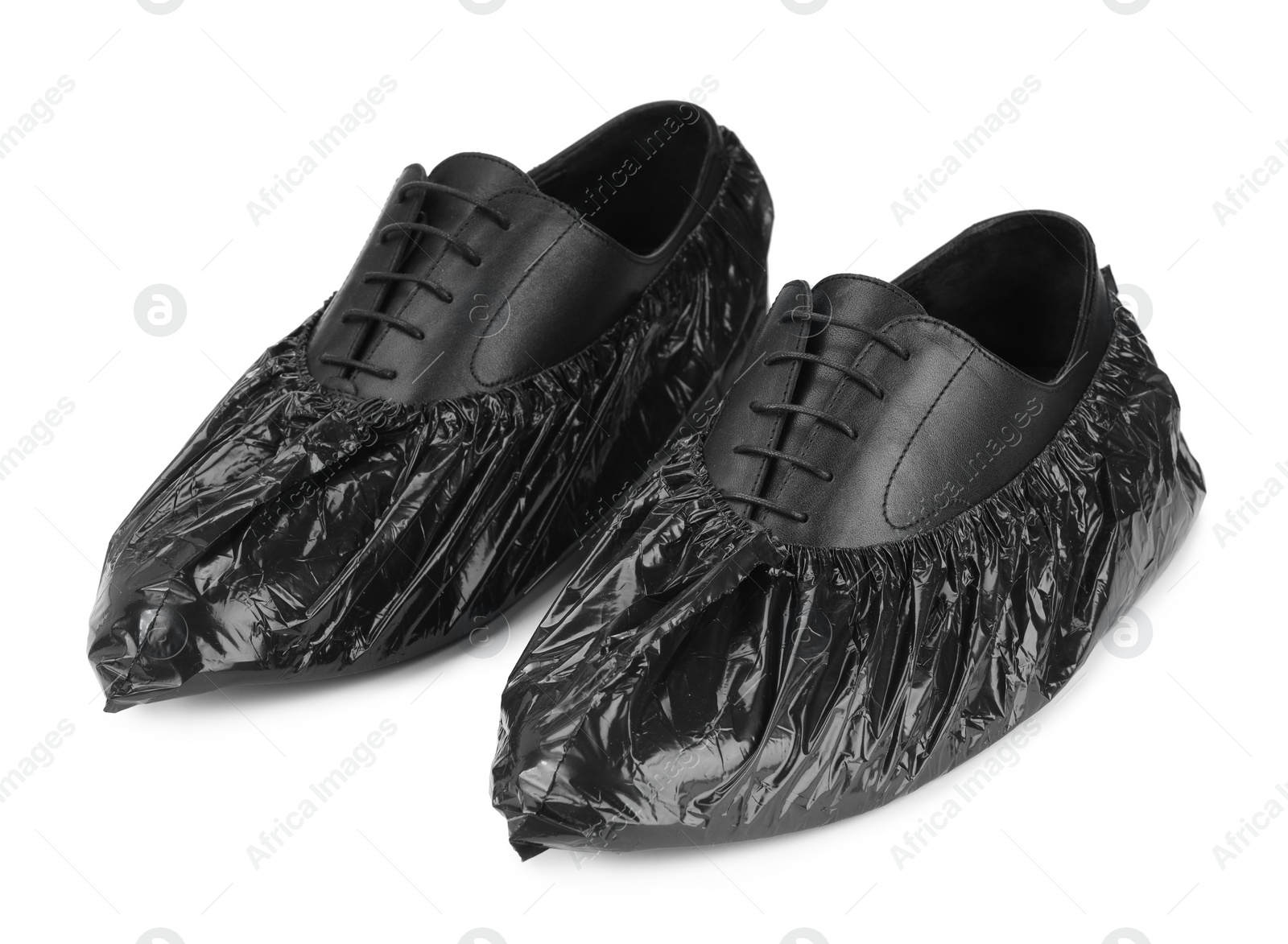Photo of Men's shoes in black shoe covers isolated on white