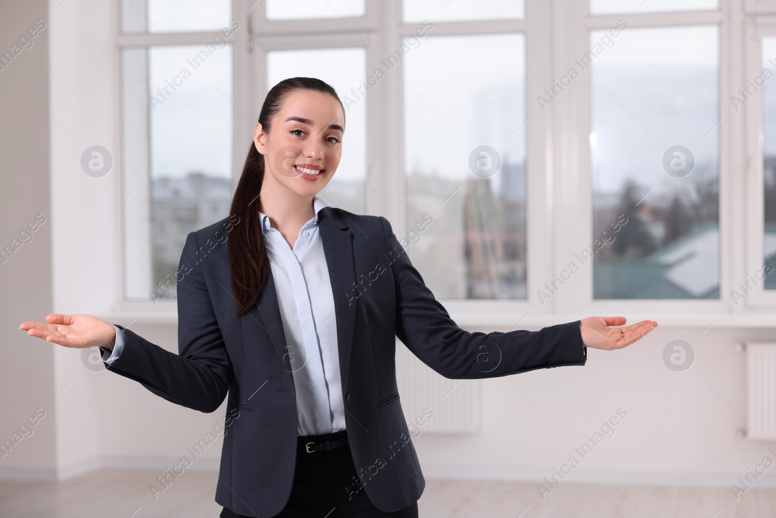 Photo of Happy real estate agent showing new apartment