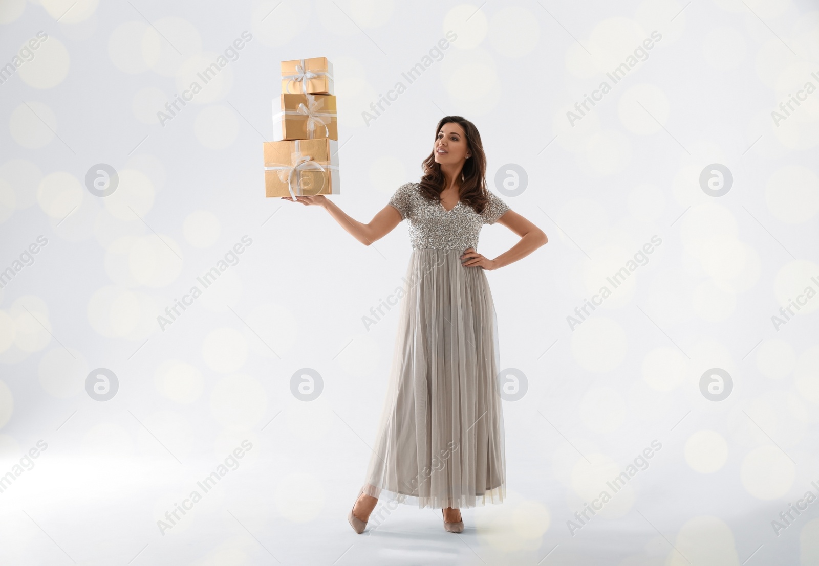 Photo of Beautiful woman with Christmas gifts on white background
