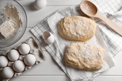 Photo of Dough, eggs and flour on white wooden table, flat lay. Cooking ciabatta
