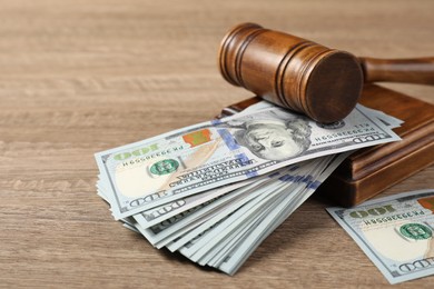 Photo of Judge's gavel and money on wooden table, closeup