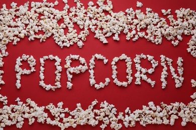 Photo of Word Popcorn made of tasty ingredients on red background, flat lay
