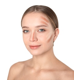 Portrait of beautiful young woman with makeup contouring smears on face against white background