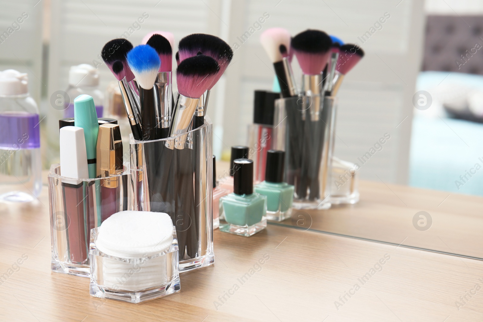 Photo of Organizer with makeup cosmetic products and space for text on dressing table