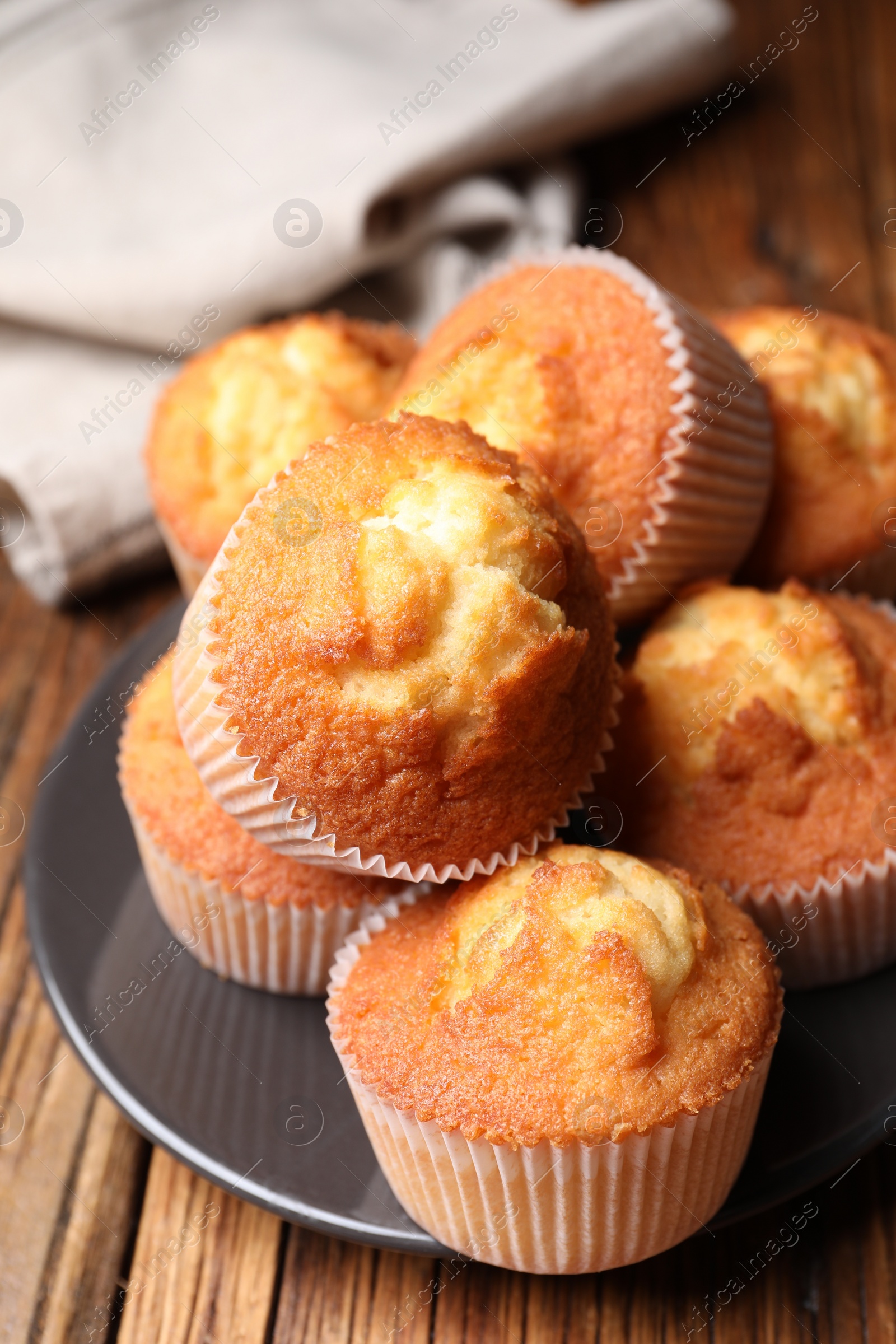 Photo of Delicious sweet muffins on wooden table, closeup