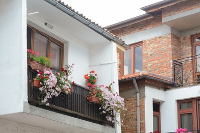 Exterior of beautiful residential buildings with balcony and flowers