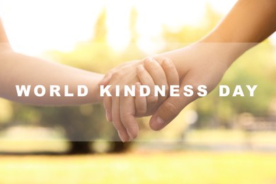 Image of World Kindness Day concept. Woman and child holding hands outdoors, closeup