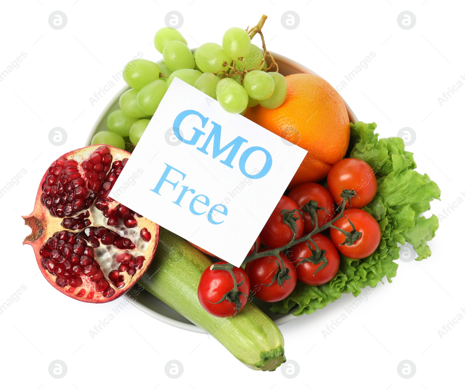 Photo of Fresh fruits, vegetables and card with text GMO Free in bowl on white background, top view