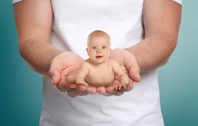 Image of Surrogacy concept. Man holding cute little baby on color background, closeup