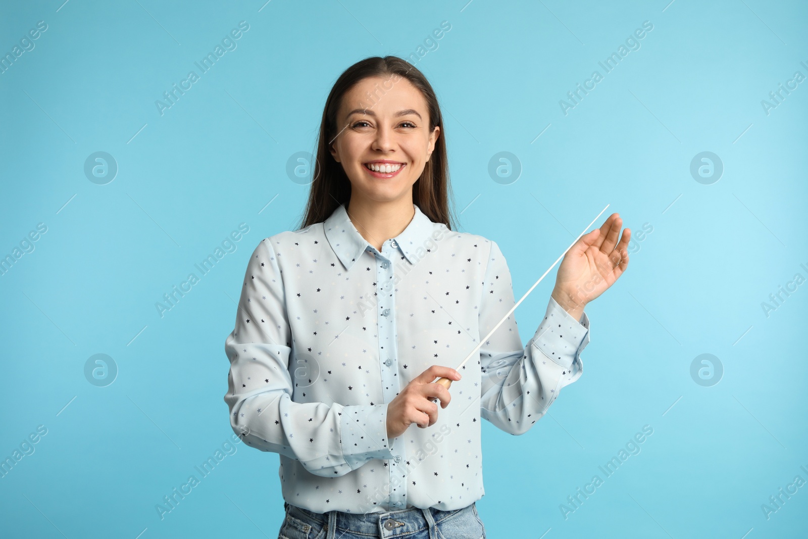 Photo of Music teacher with baton on turquoise background
