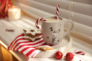 Photo of Composition with cup of hot drink on windowsill