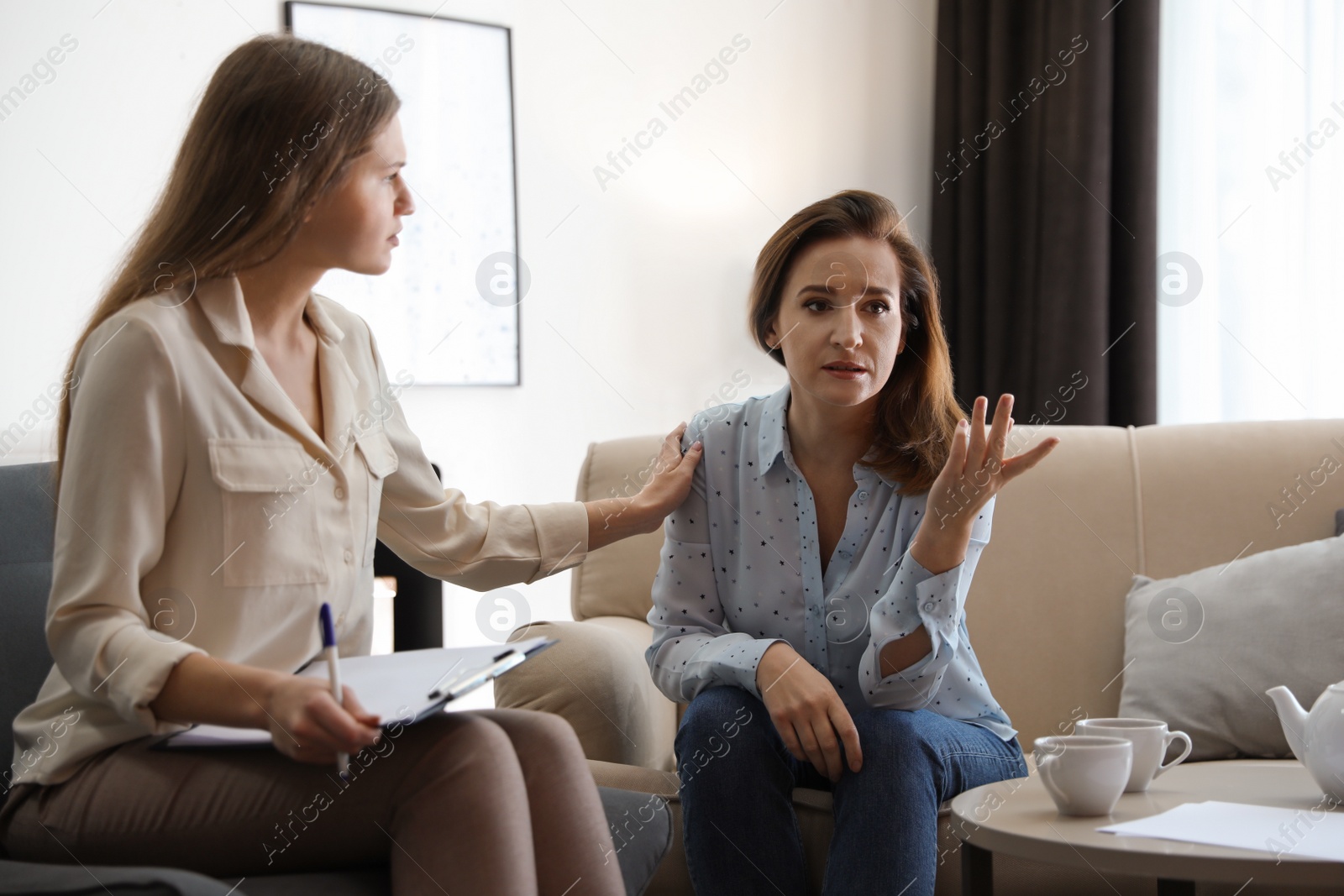 Photo of Professional psychotherapist working with patient in office