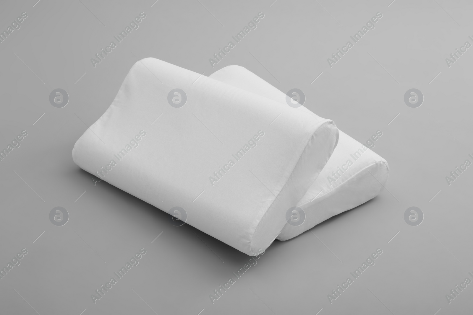 Photo of Clean soft orthopedic pillows on grey background