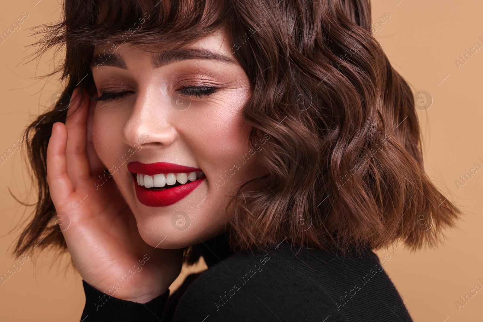 Photo of Beautiful young woman with wavy hairstyle on beige background