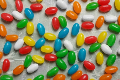 Flat lay composition with delicious jelly beans on stone background