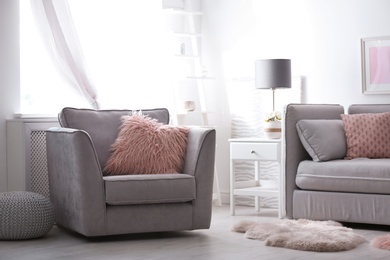 Photo of Stylish room interior with comfortable armchair and sofa