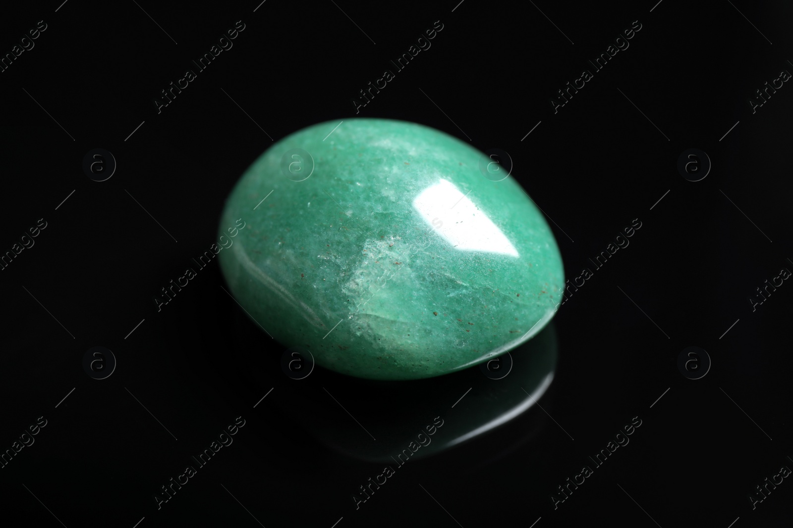 Photo of Beautiful green aventurine gemstone on black background