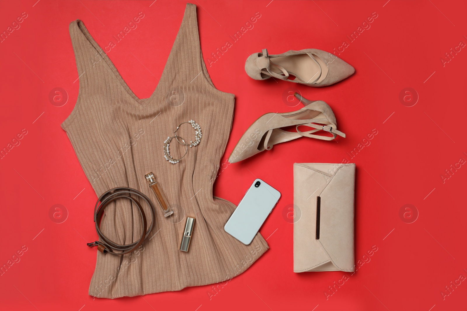 Photo of Stylish shoes, new clothes, smartphone and accessories on red background, flat lay