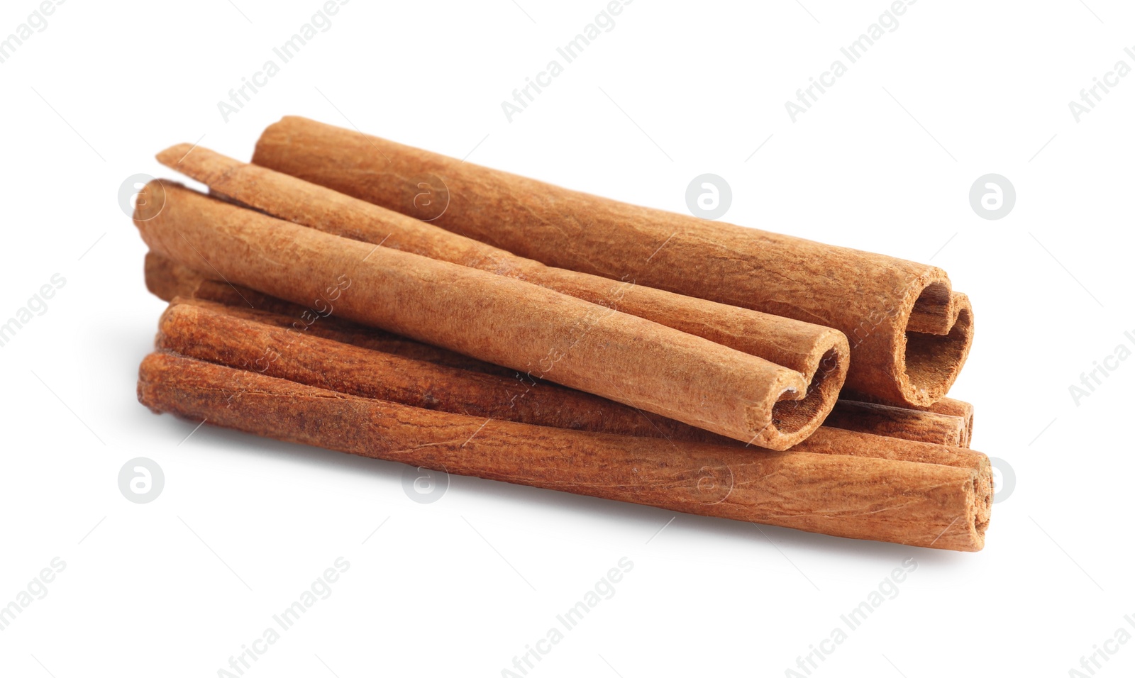 Photo of Pile of aromatic cinnamon sticks isolated on white