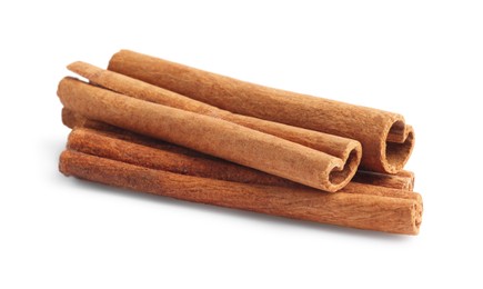 Photo of Pile of aromatic cinnamon sticks isolated on white