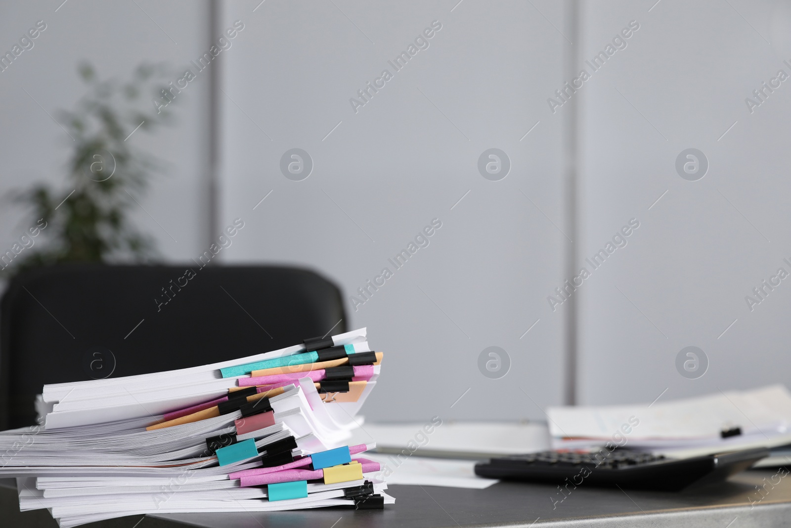 Photo of Stack of documents with paper clips on office table. Space for text