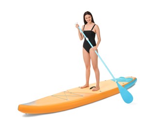 Happy woman with paddle on orange SUP board against white background