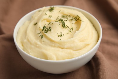 Freshly cooked homemade mashed potatoes on brown fabric