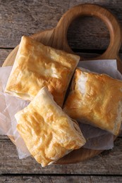Photo of Delicious puff pastry on wooden table, top view