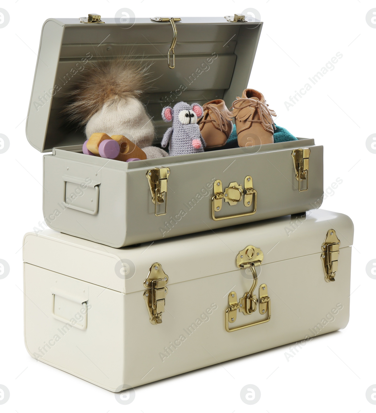 Photo of Stylish storage trunks with child's shoes and toys on white background. Interior elements