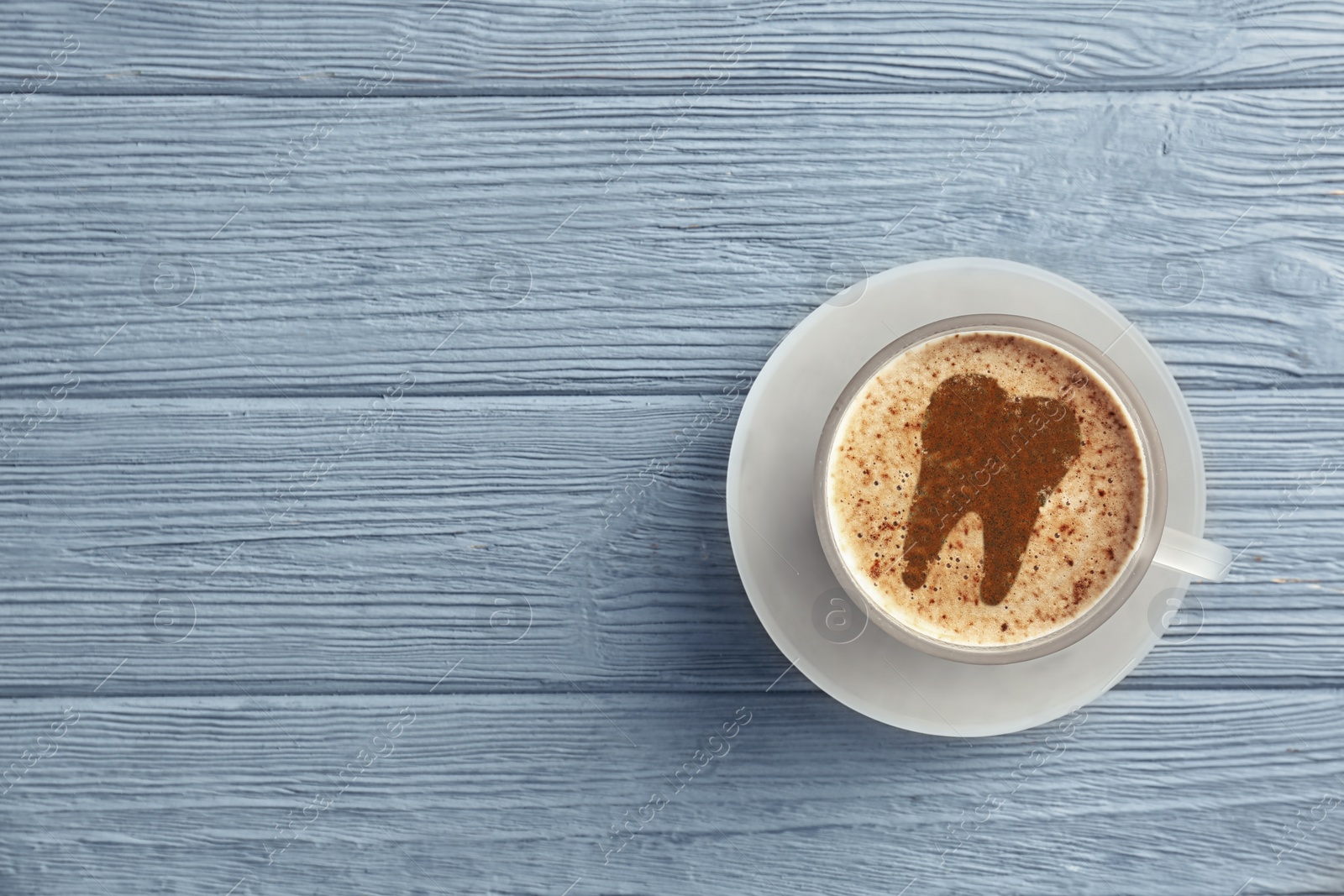 Image of Coffee causing dental problem. Cup of hot drink on wooden background, top view