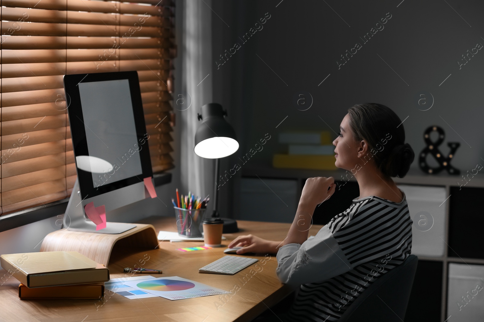 Photo of Female designer working at desk in office