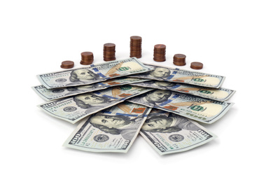 Dollar banknotes and stacks of coins on white background