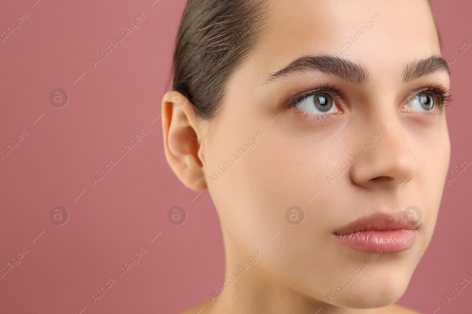 Photo of Young woman with perfect eyebrows on pink background, space for text