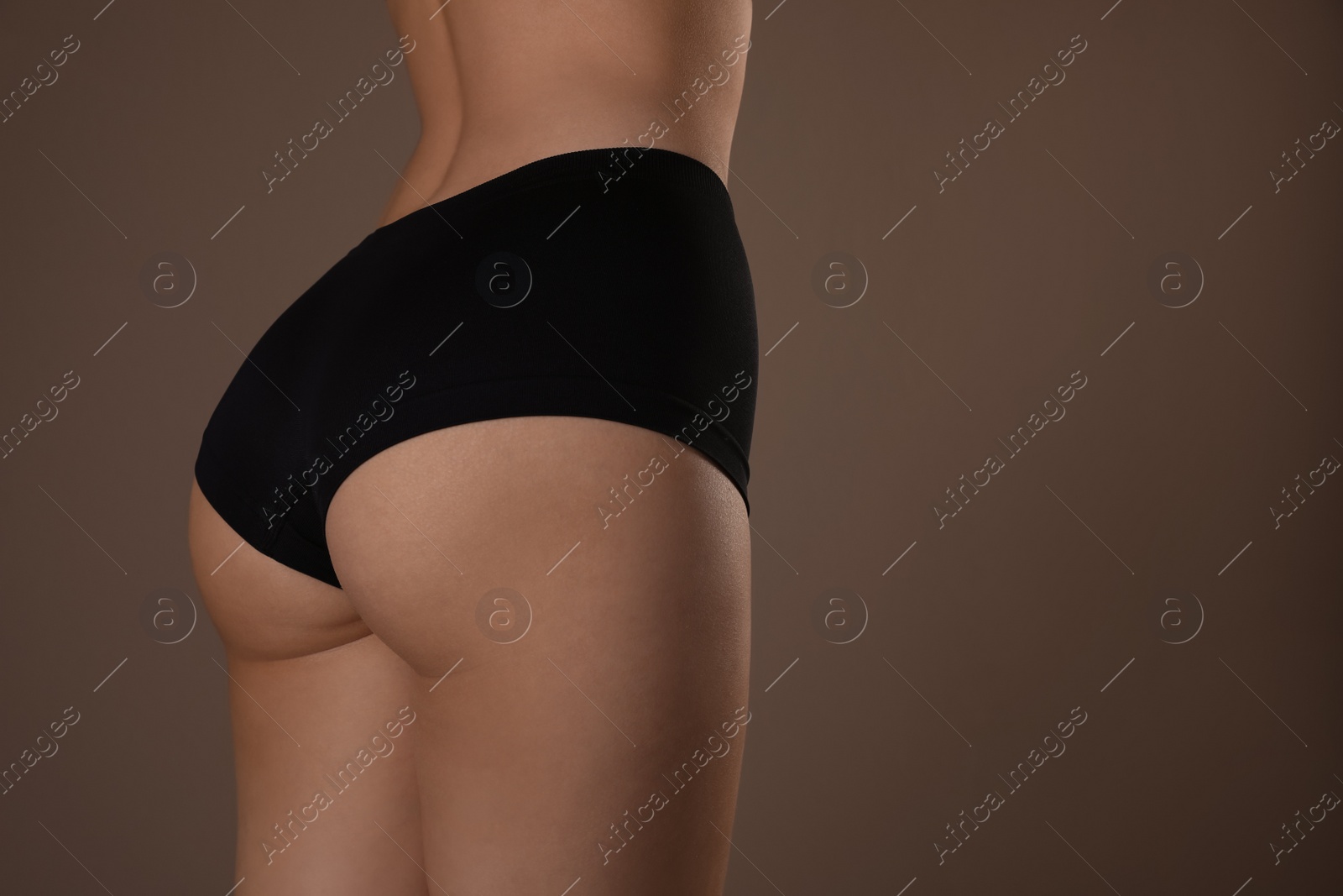 Photo of Closeup view of slim woman with smooth skin in underwear on beige background, space for text. Cellulite problem concept