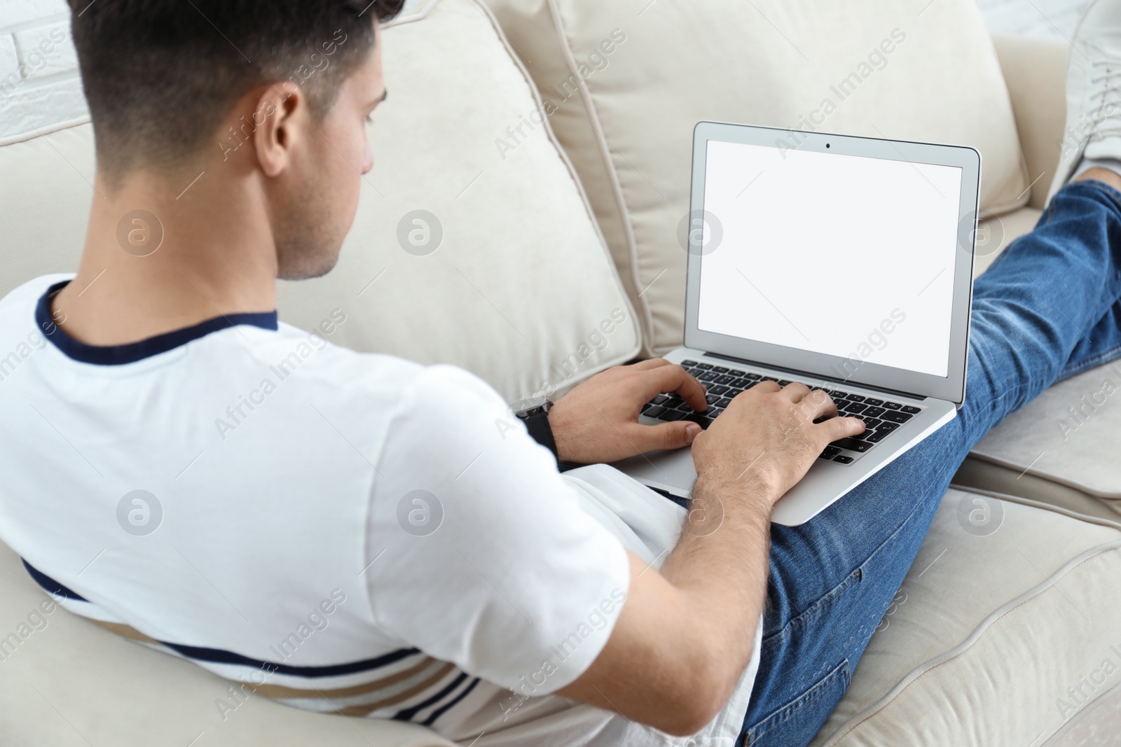 Photo of Man working on modern laptop at home