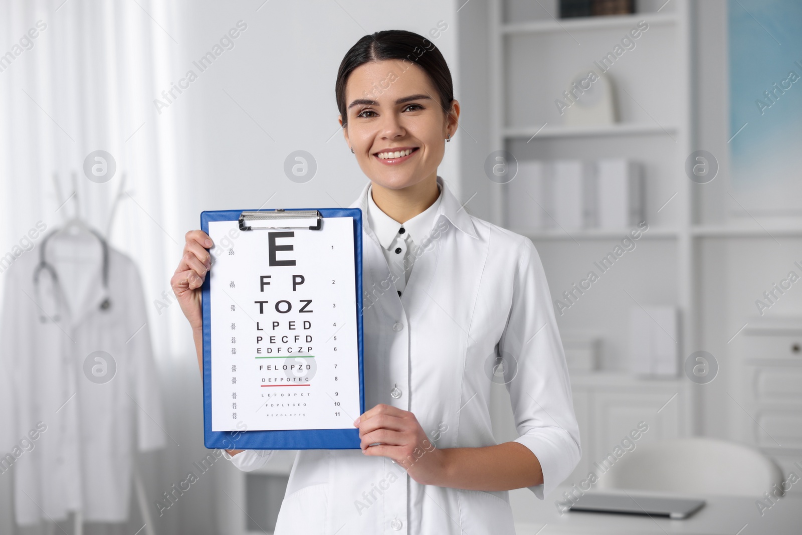 Photo of Ophthalmologist with vision test chart in clinic