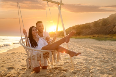 Photo of Happy young couple on beach at sunset