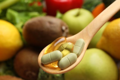 Photo of Dietary supplements. Spoon with different pills over food products, closeup