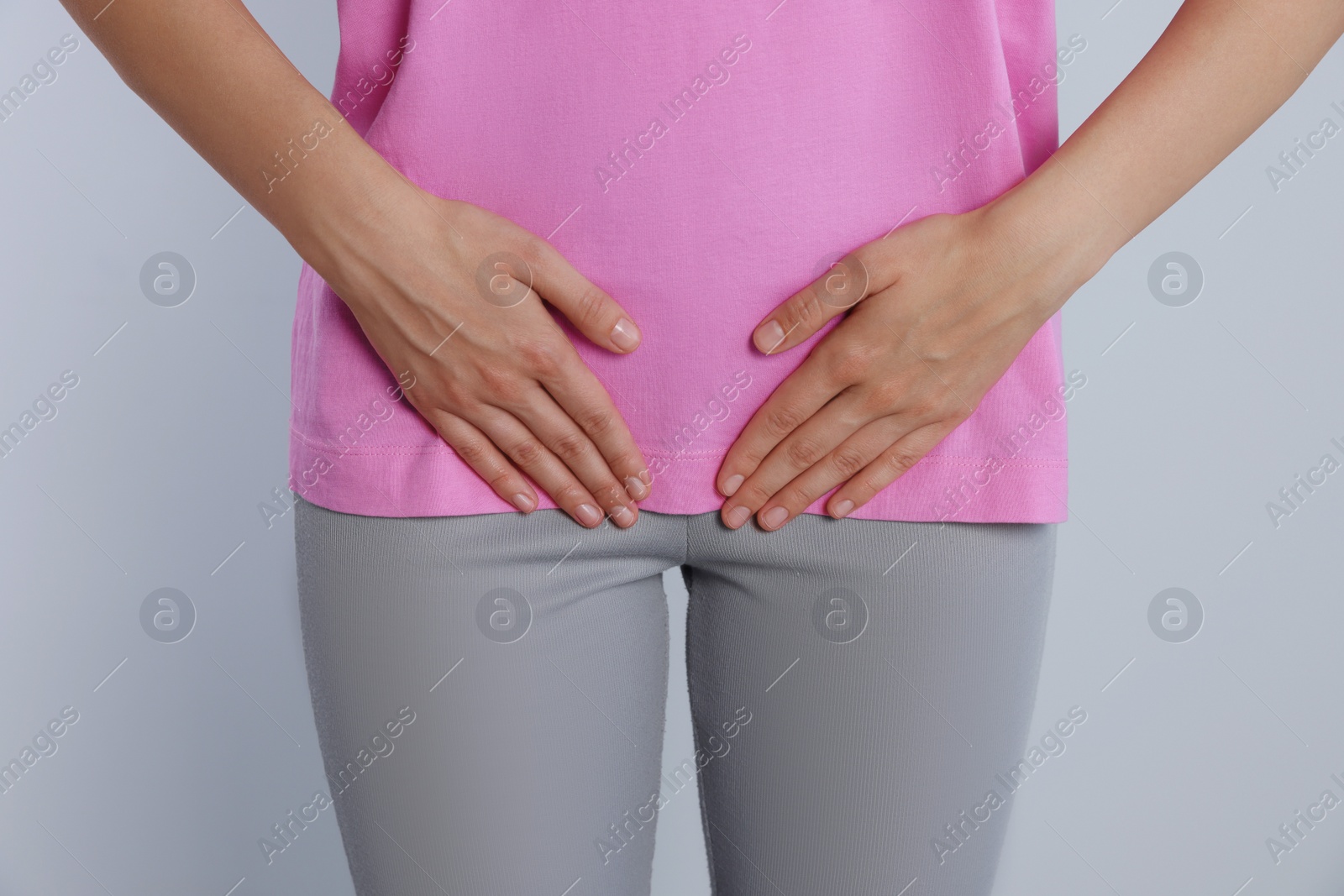 Photo of Woman suffering from herpes genital on grey background, closeup