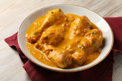 Tasty fresh chicken curry on wooden table