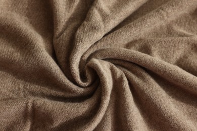 Photo of Beautiful light brown fabric as background, top view