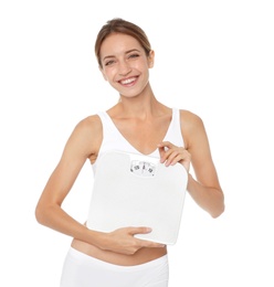 Happy slim woman satisfied with her diet results holding bathroom scales on white background